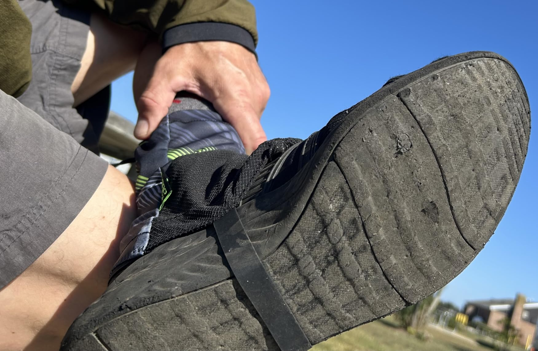 Customer photo showing a gaiter worn outdoors, with the strap secured beneath the shoe