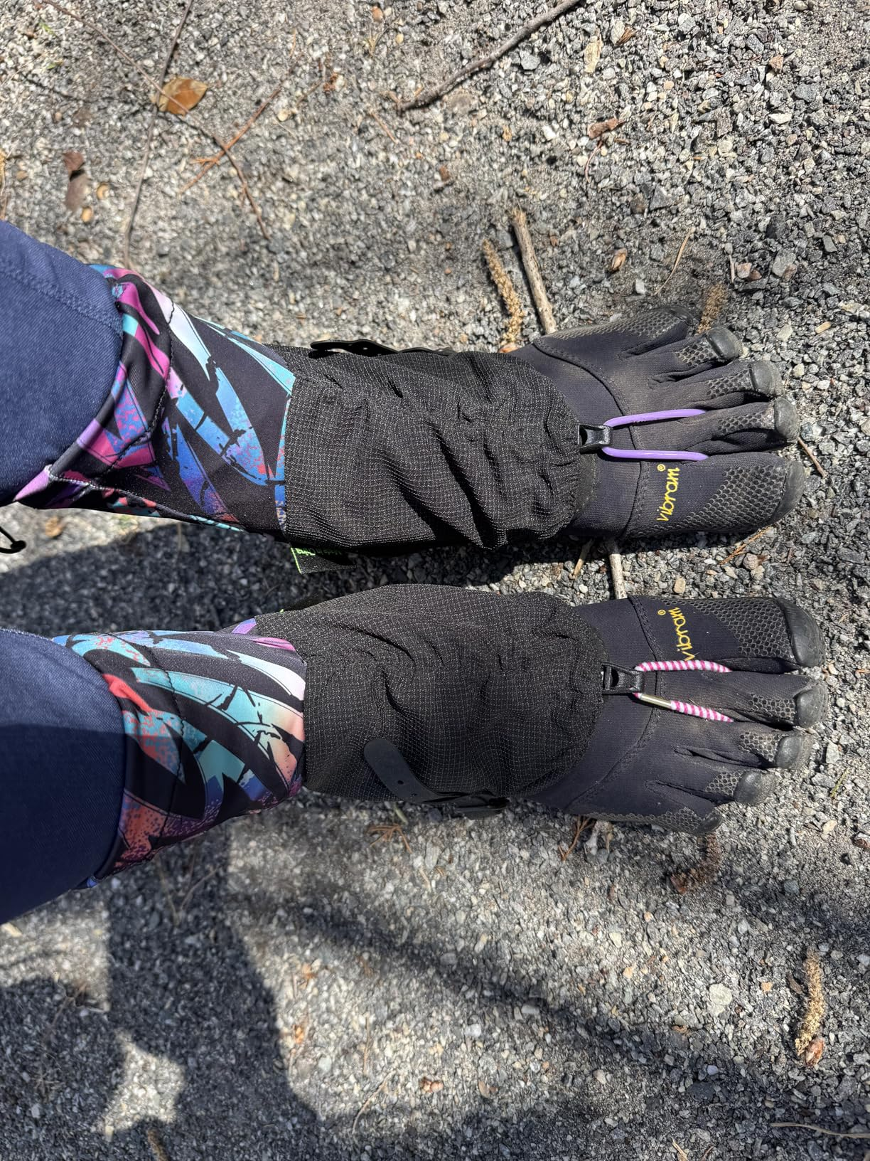 Customer photo of colorful gaiters worn over toe shoes outdoors, with hair ties connecting the front hooks